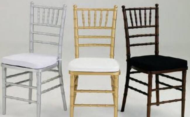 Three Chiavari chairs in different colors: silver, gold, and dark brown, each with differently colored cushions.